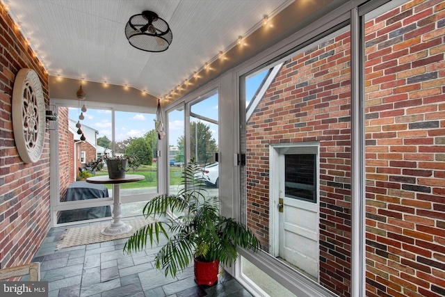 unfurnished sunroom featuring vaulted ceiling