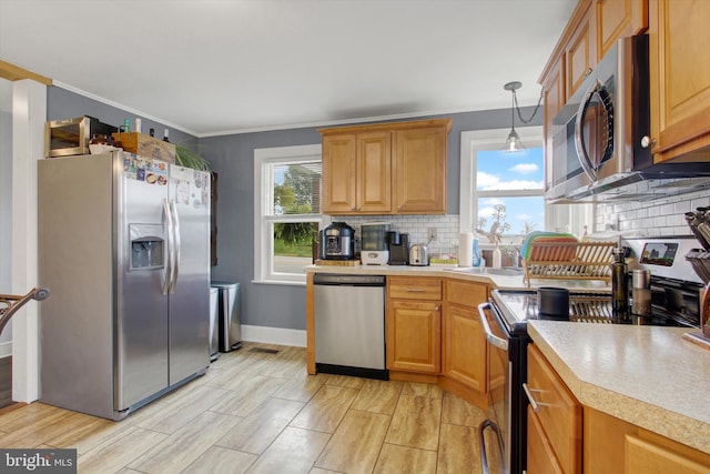 kitchen featuring a sink, light countertops, backsplash, and stainless steel appliances