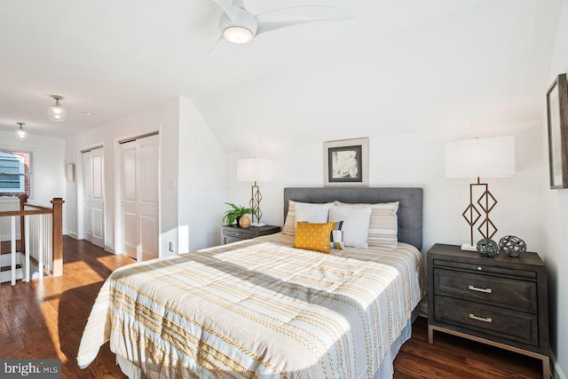 bedroom featuring two closets and wood finished floors