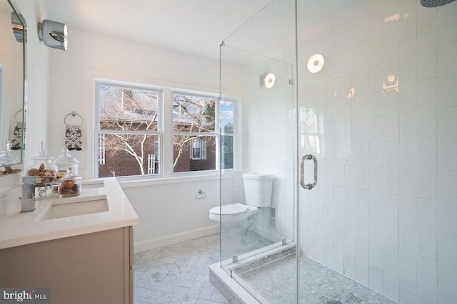 full bathroom with vanity, a stall shower, and marble finish floor