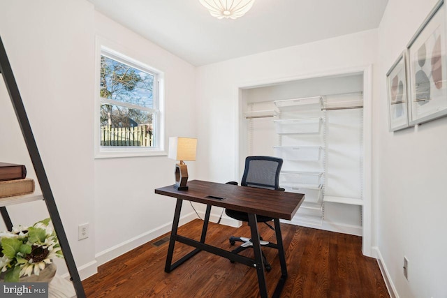 home office featuring visible vents, baseboards, and wood finished floors