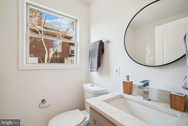 bathroom featuring toilet and vanity