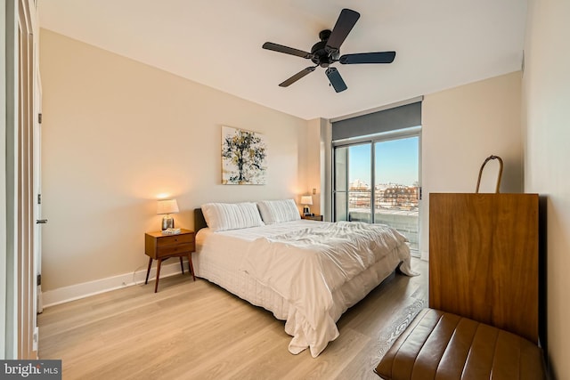 bedroom featuring a ceiling fan, access to exterior, baseboards, and light wood-type flooring