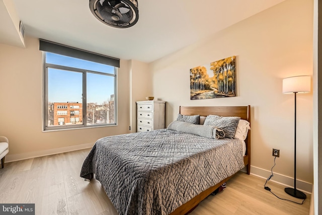 bedroom featuring baseboards and wood finished floors