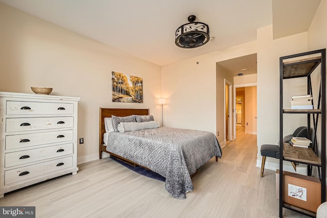 bedroom with baseboards and light wood-style floors