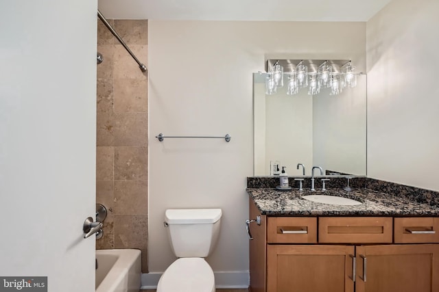 full bathroom featuring vanity, toilet, baseboards, and shower / washtub combination