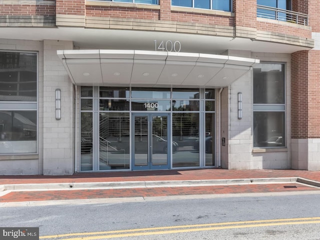 property entrance featuring brick siding