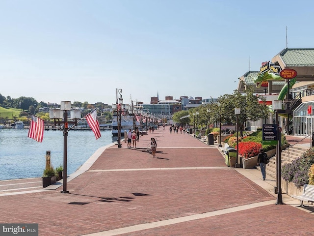 surrounding community featuring a water view and a dock