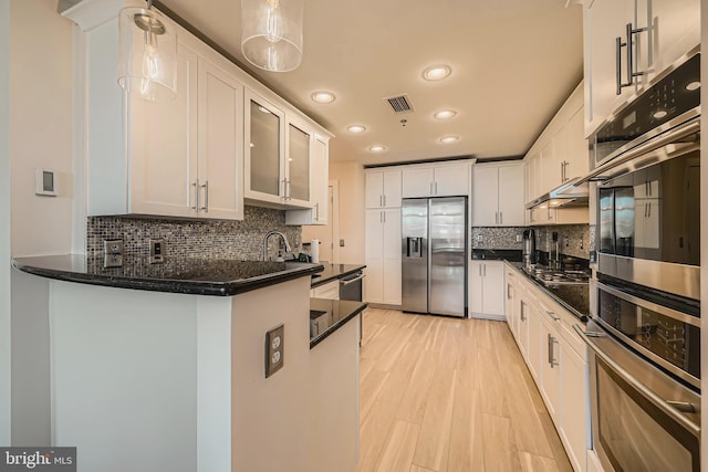 kitchen featuring visible vents, appliances with stainless steel finishes, and white cabinetry