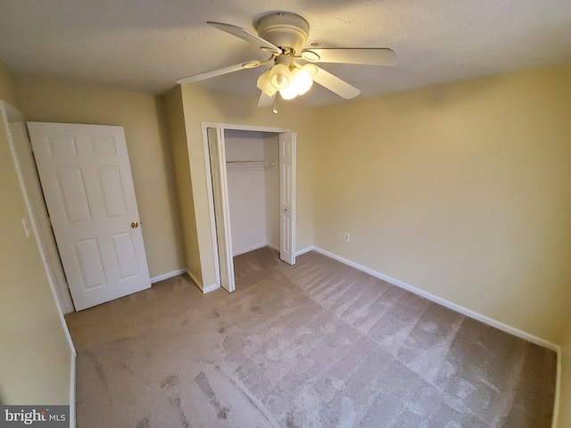 unfurnished bedroom with a ceiling fan, light colored carpet, a closet, and baseboards