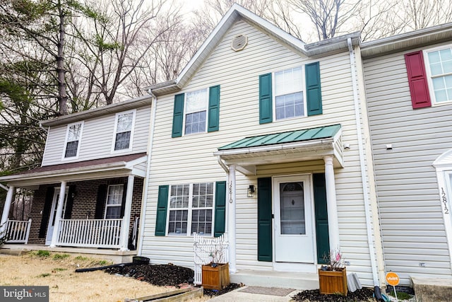 view of property featuring covered porch