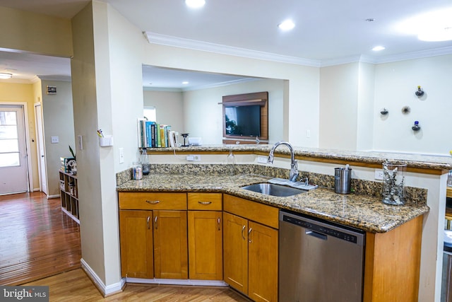 kitchen with dishwasher, light wood-type flooring, light stone counters, brown cabinets, and a sink