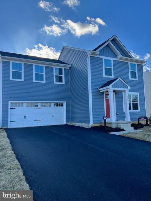 view of front of house featuring aphalt driveway and an attached garage