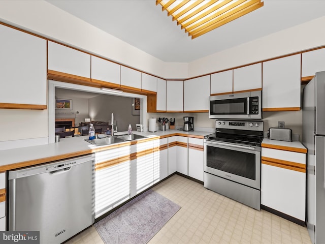 kitchen featuring a sink, stainless steel appliances, and light countertops