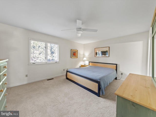 carpeted bedroom featuring a ceiling fan, baseboards, and visible vents