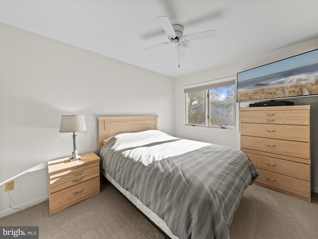 bedroom with baseboards, light carpet, and ceiling fan