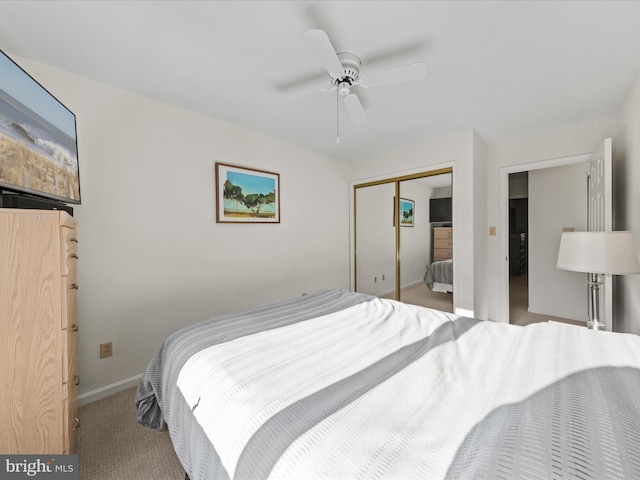 carpeted bedroom featuring a closet, a ceiling fan, and baseboards