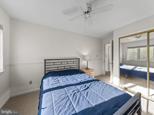 bedroom featuring a ceiling fan, carpet flooring, baseboards, and a closet