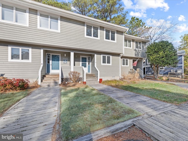 view of front of property featuring entry steps, a front yard, and crawl space