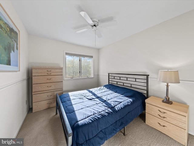 bedroom with baseboards, a ceiling fan, and carpet