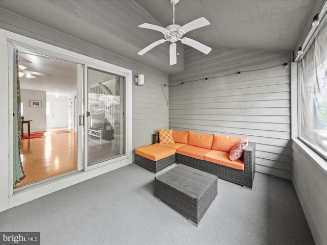 sunroom with lofted ceiling, a healthy amount of sunlight, and ceiling fan