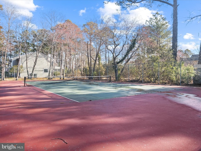 view of tennis court featuring fence