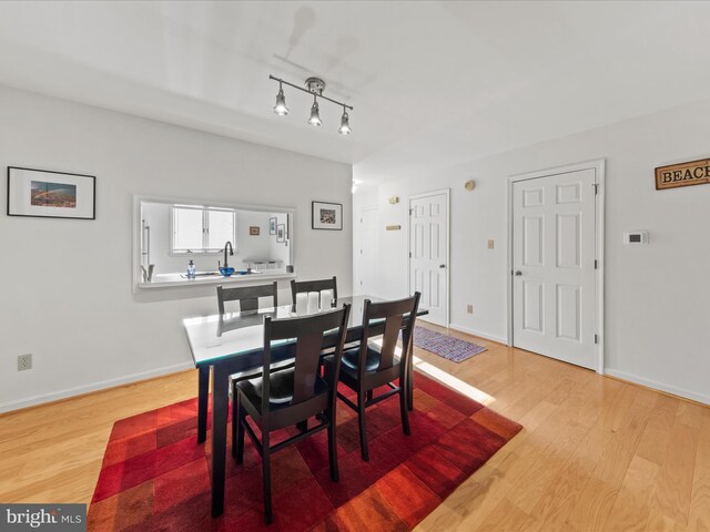 dining room with light wood finished floors and baseboards