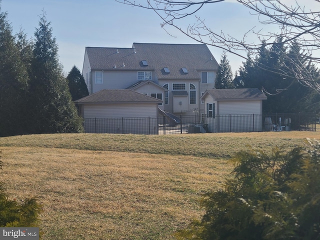 view of front of home with cooling unit, a garage, a front yard, and fence