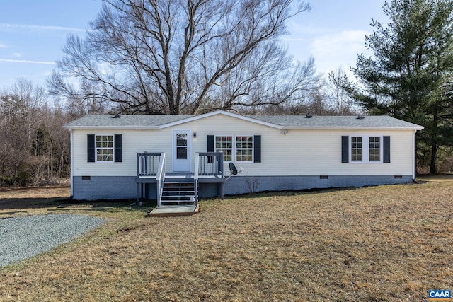 manufactured / mobile home with a front yard, a wooden deck, and crawl space