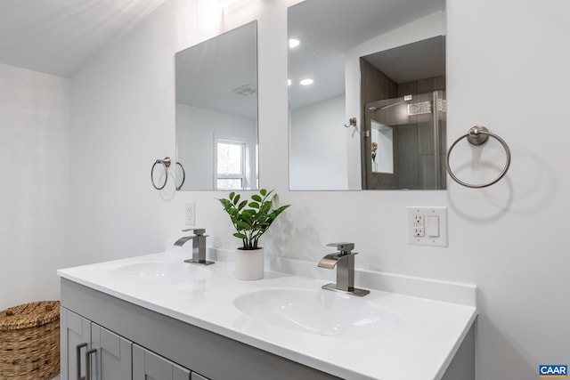 full bathroom featuring a sink, recessed lighting, and double vanity