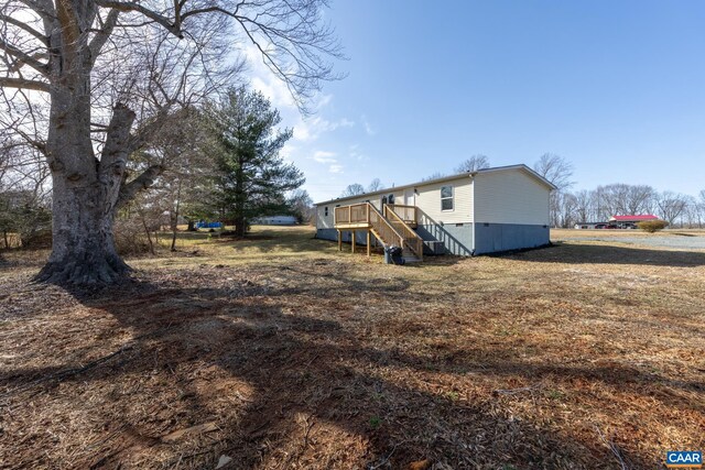 view of yard featuring stairs and a deck