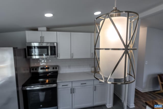 kitchen featuring decorative backsplash, recessed lighting, appliances with stainless steel finishes, and white cabinets