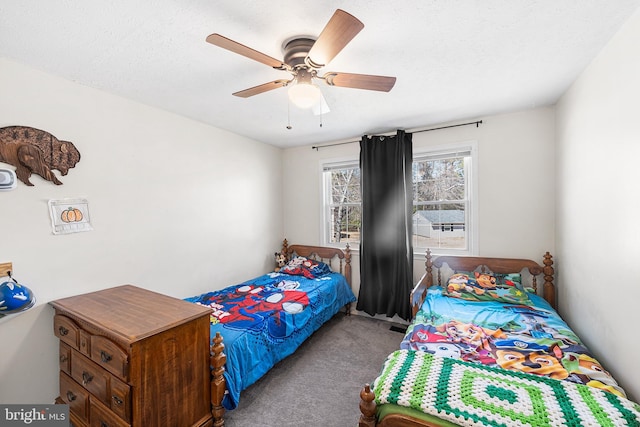 carpeted bedroom featuring a textured ceiling and a ceiling fan