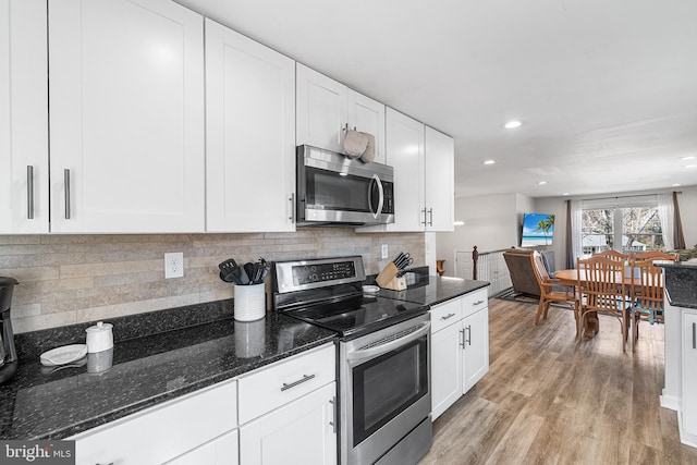 kitchen featuring light wood-style flooring, white cabinetry, and stainless steel appliances