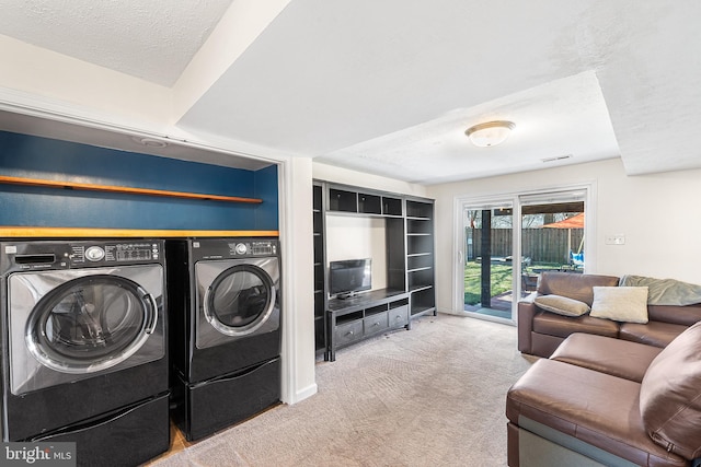 laundry area with visible vents, laundry area, carpet flooring, a textured ceiling, and separate washer and dryer