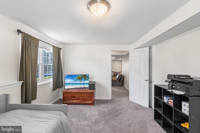 carpeted bedroom featuring baseboards