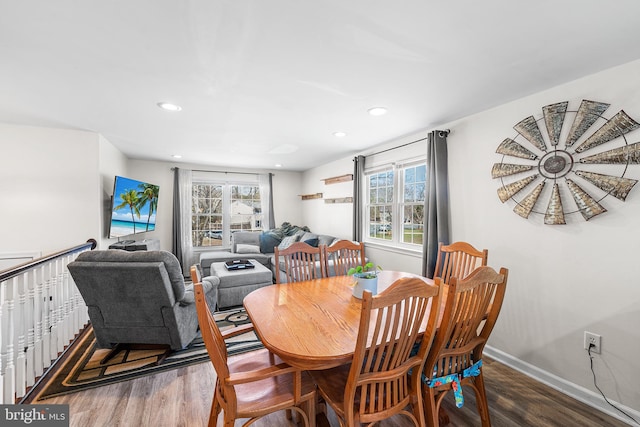 dining room featuring recessed lighting, wood finished floors, baseboards, and a wealth of natural light