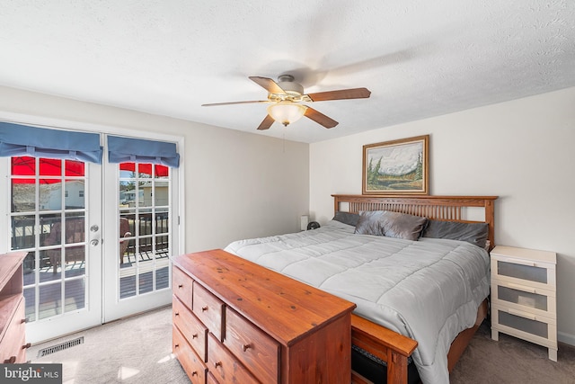 bedroom with visible vents, french doors, a textured ceiling, access to outside, and light colored carpet