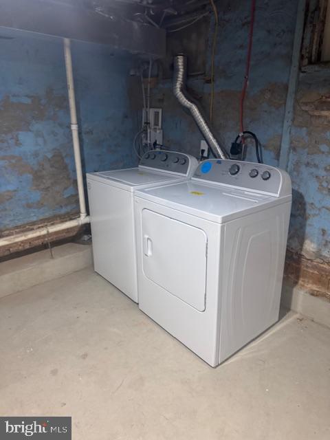 clothes washing area featuring laundry area and washing machine and clothes dryer