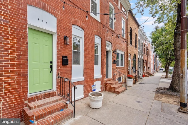 doorway to property featuring brick siding