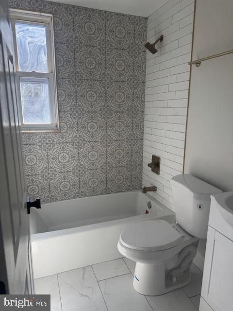full bath with marble finish floor, vanity, toilet, and bathing tub / shower combination
