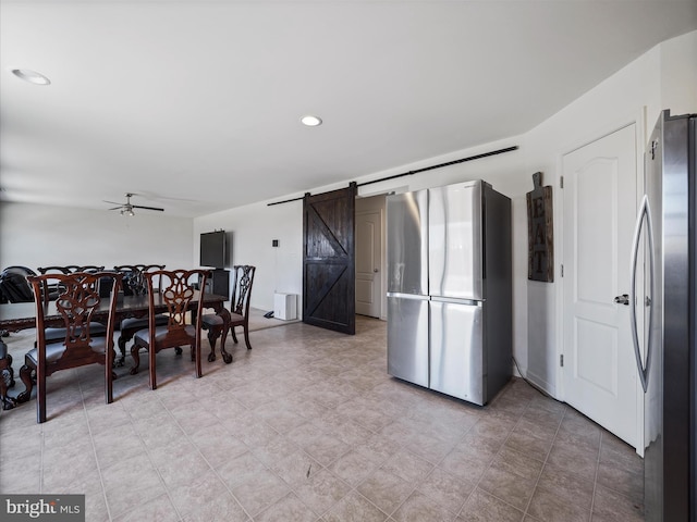 dining space featuring a barn door, recessed lighting, and ceiling fan