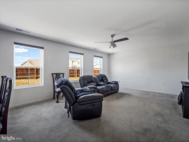 living room with visible vents, baseboards, carpet, and ceiling fan