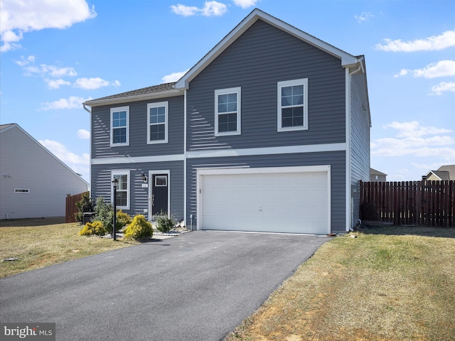 traditional home with driveway, a front lawn, a garage, and fence