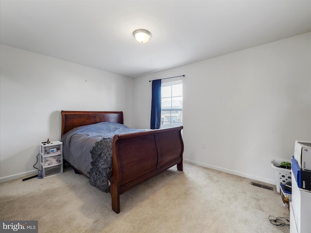 carpeted bedroom featuring visible vents and baseboards