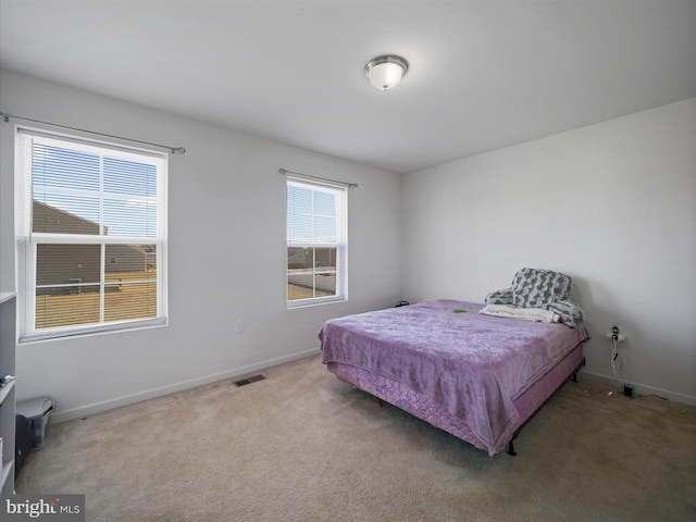 bedroom featuring visible vents, baseboards, and carpet flooring