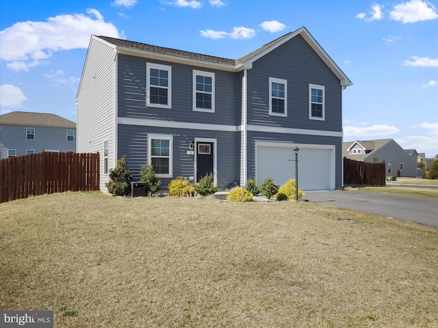 view of front of property with aphalt driveway, fence, a garage, and a front yard