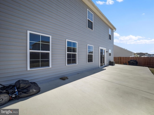 back of property with a patio area, central AC unit, and fence