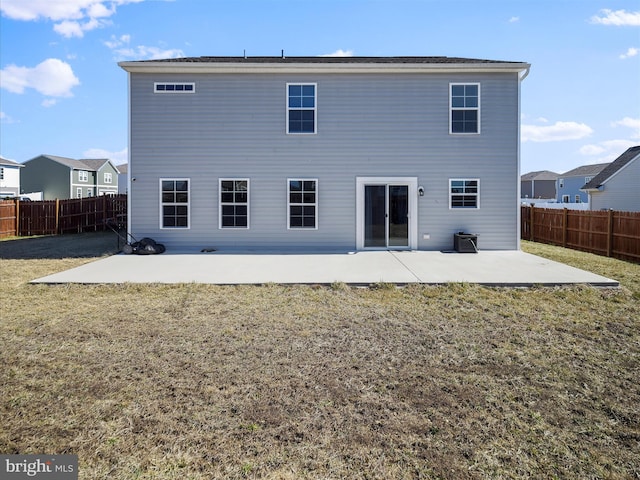 rear view of property with a yard, a fenced backyard, and a patio area