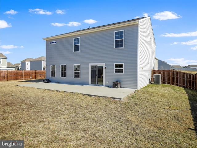 back of house featuring a patio, cooling unit, a lawn, and a fenced backyard